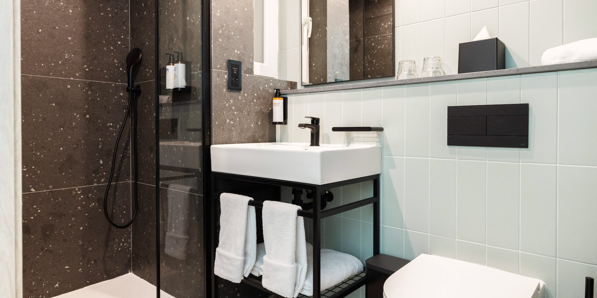 a bathroom with a shower and sink