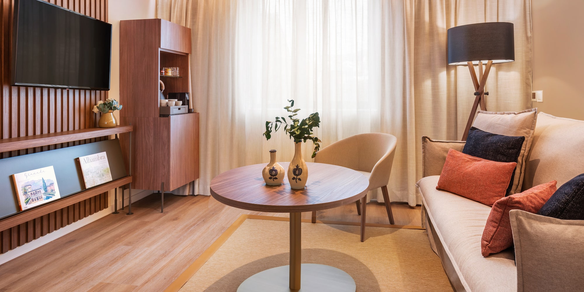 a living room with a table and a tv