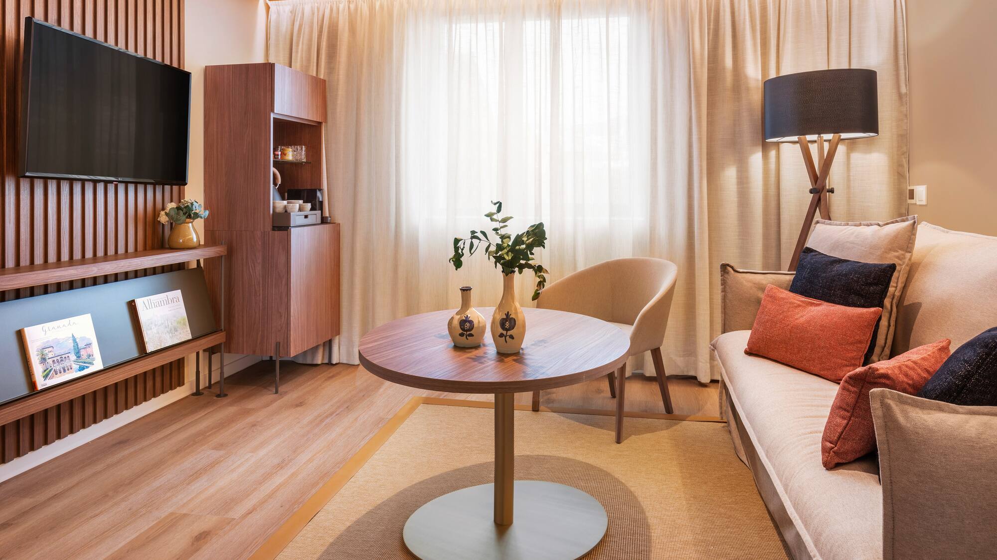 a living room with a table and a tv