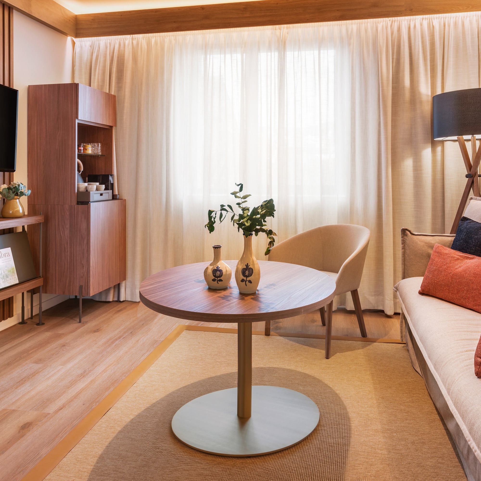 a living room with a table and a tv