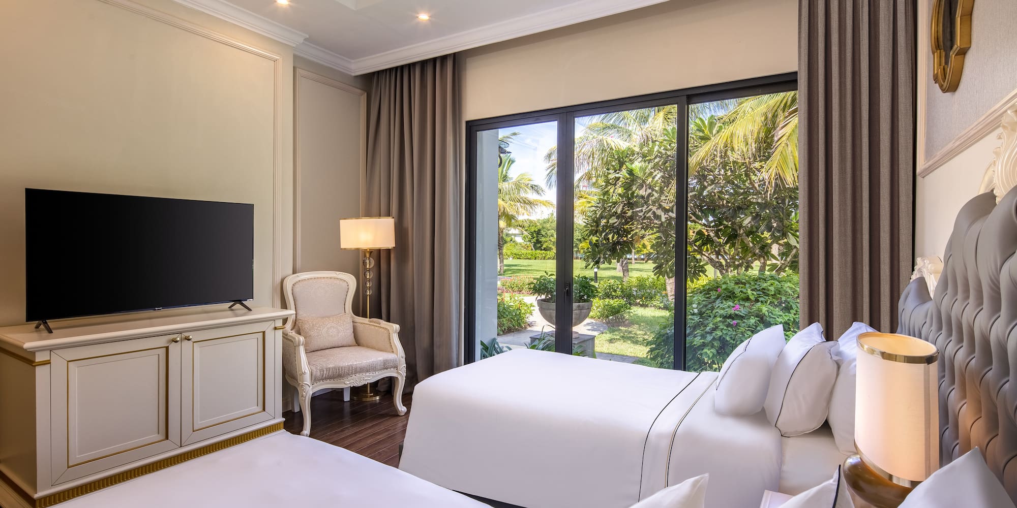 a room with two beds and a television