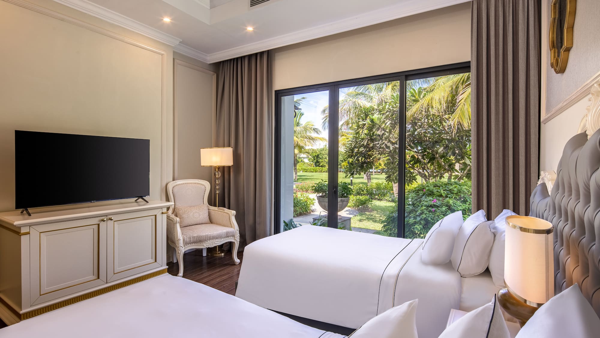 a room with two beds and a television