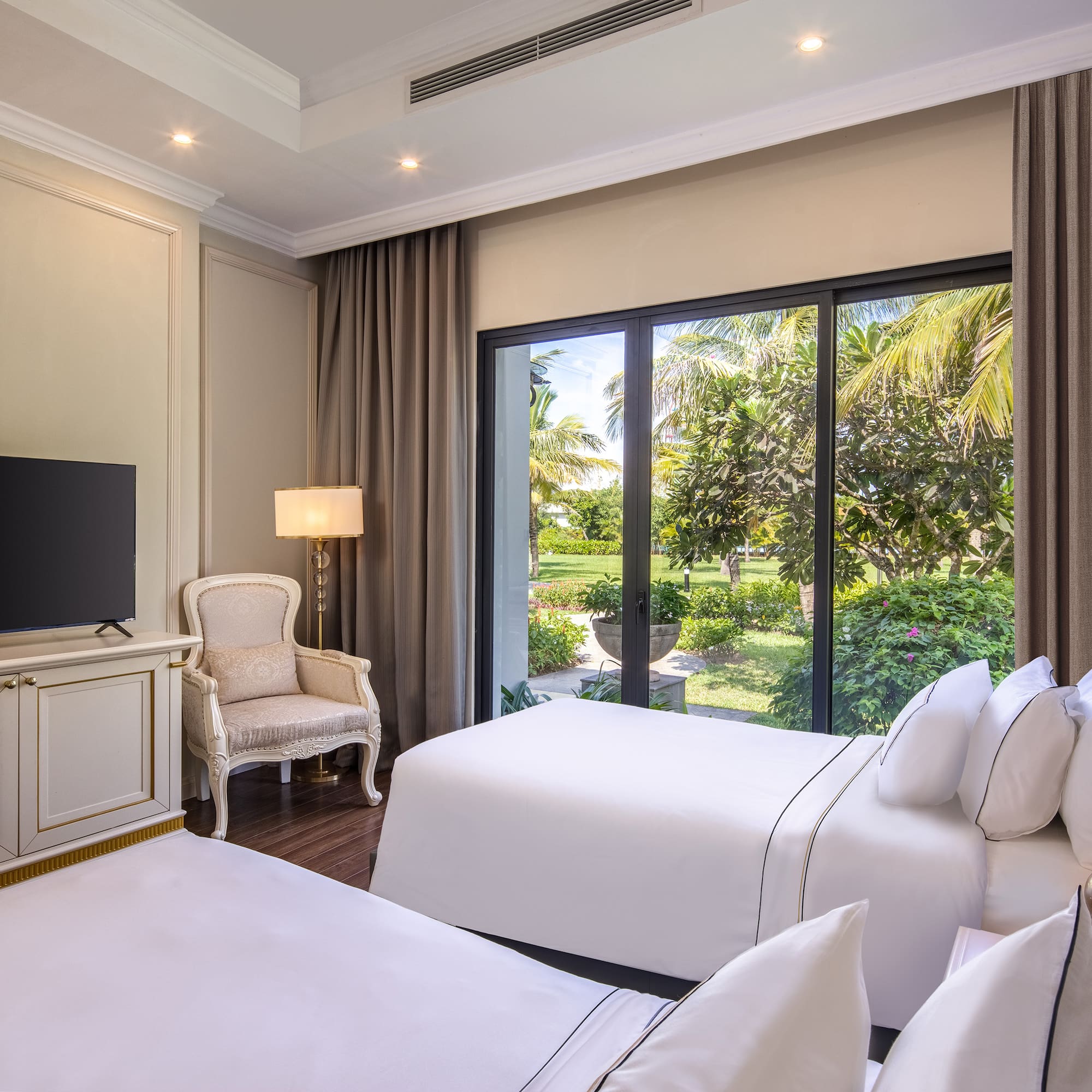 a room with two beds and a television