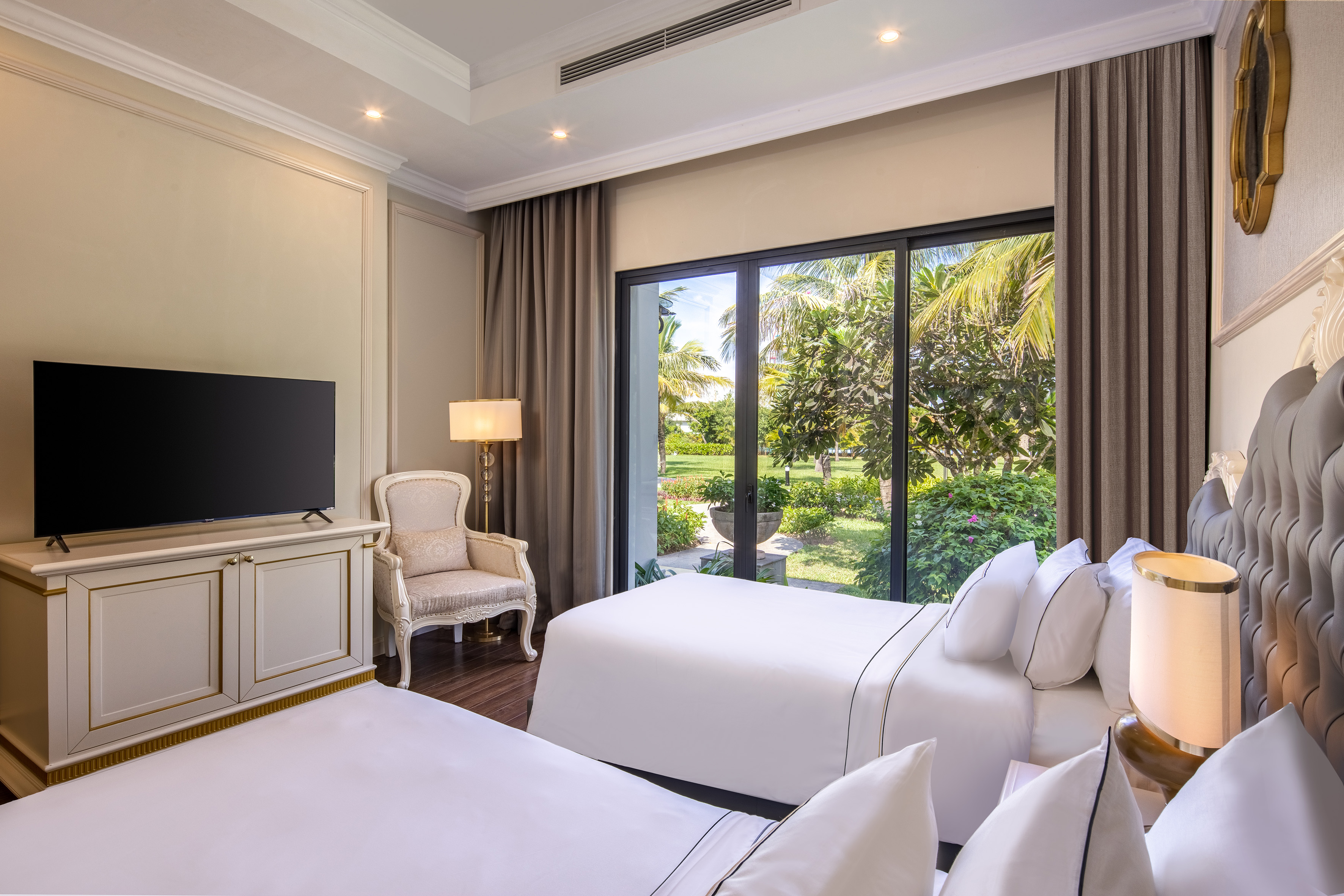 a room with two beds and a television
