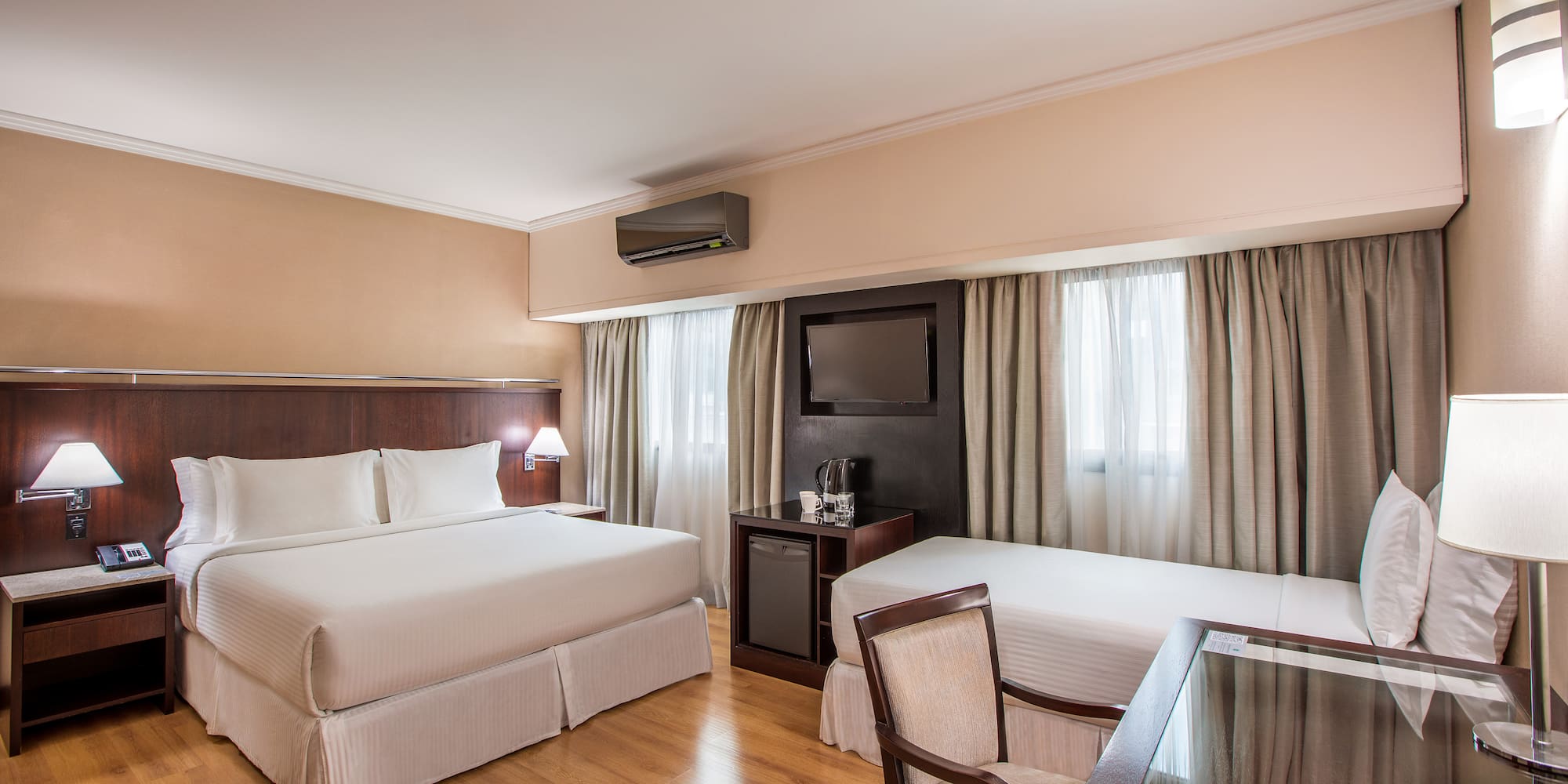 a room with two beds and a table