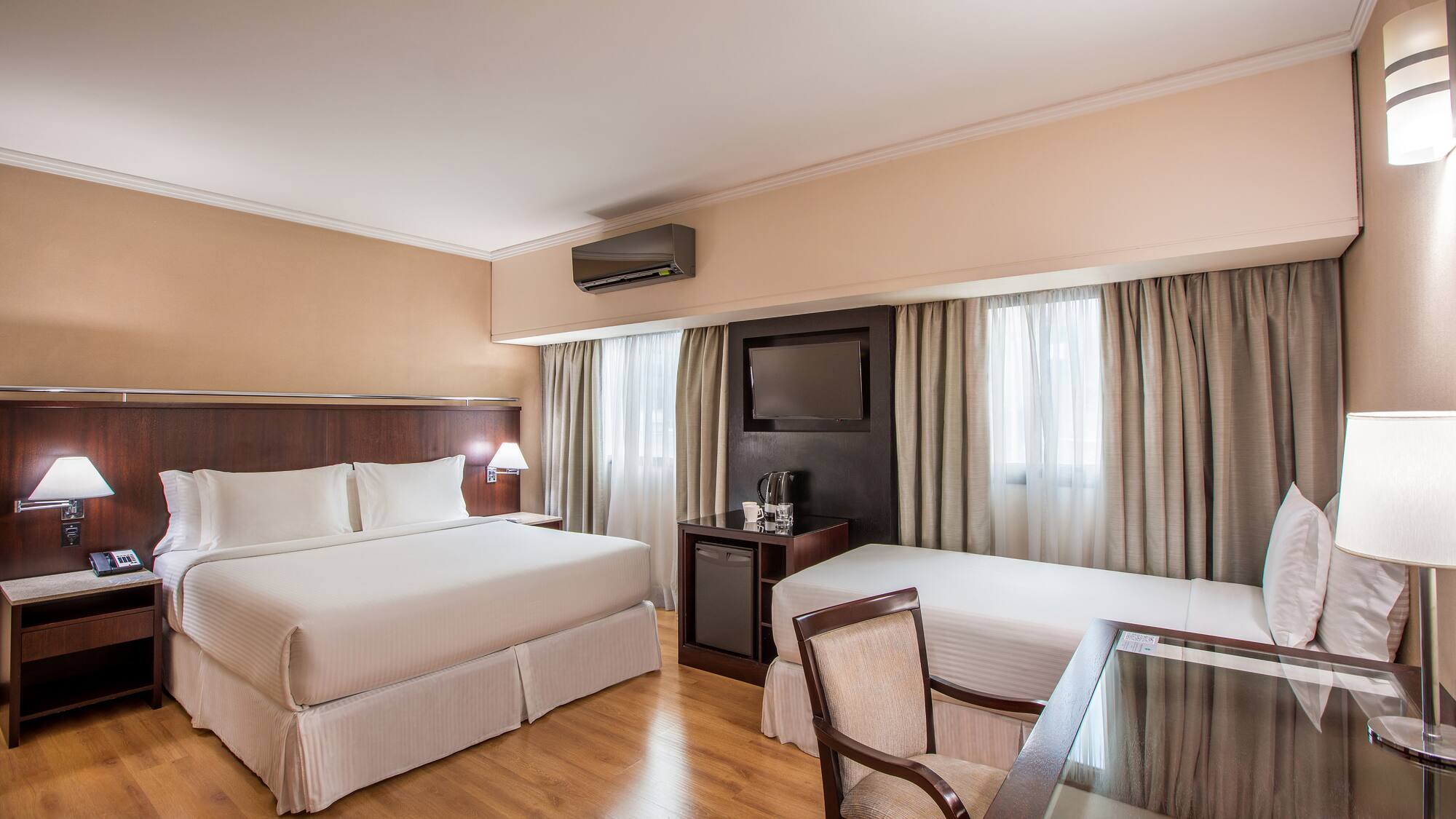 a room with two beds and a table