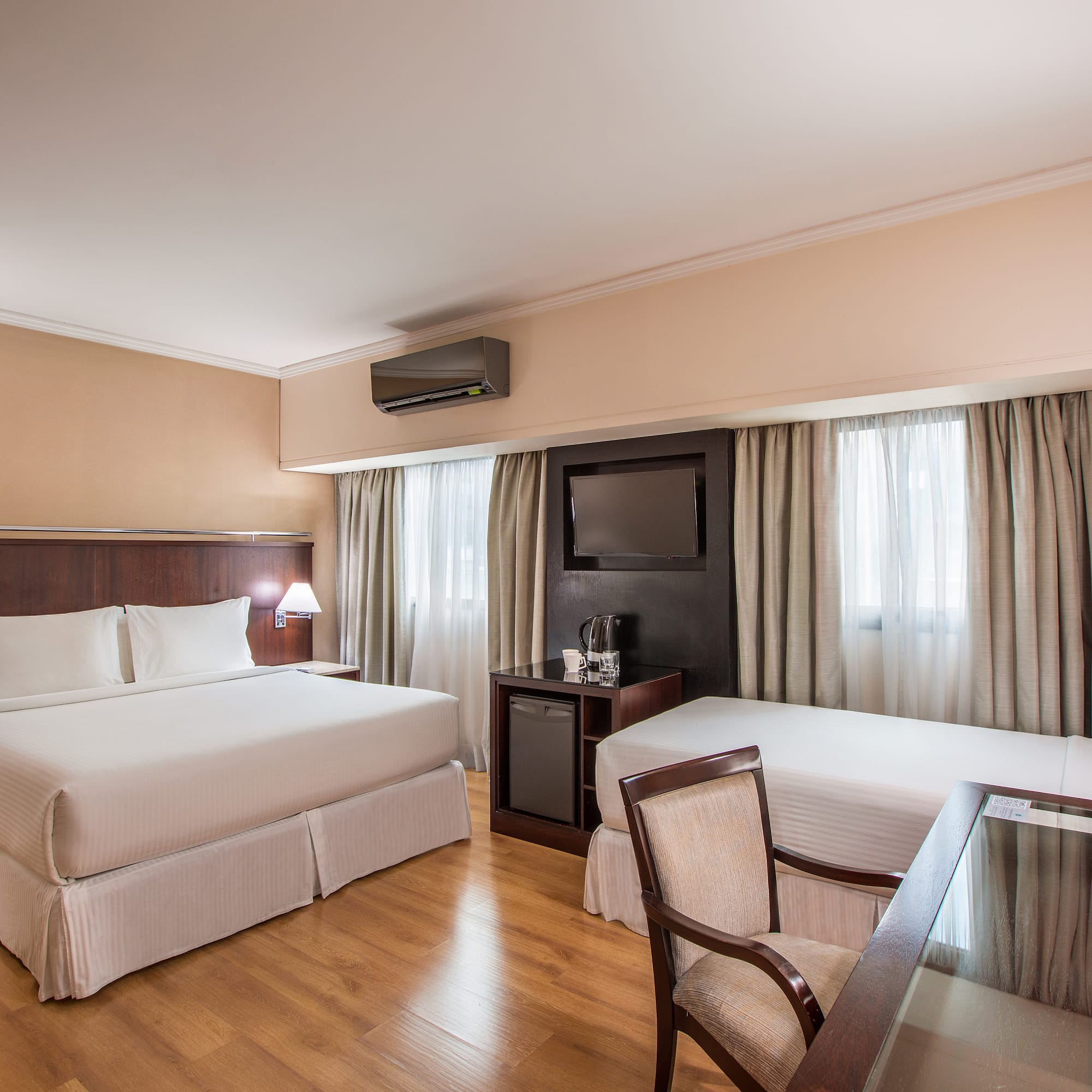 a room with two beds and a table