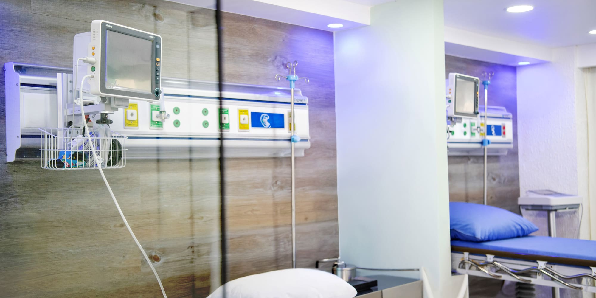 a room with a bed and a monitor