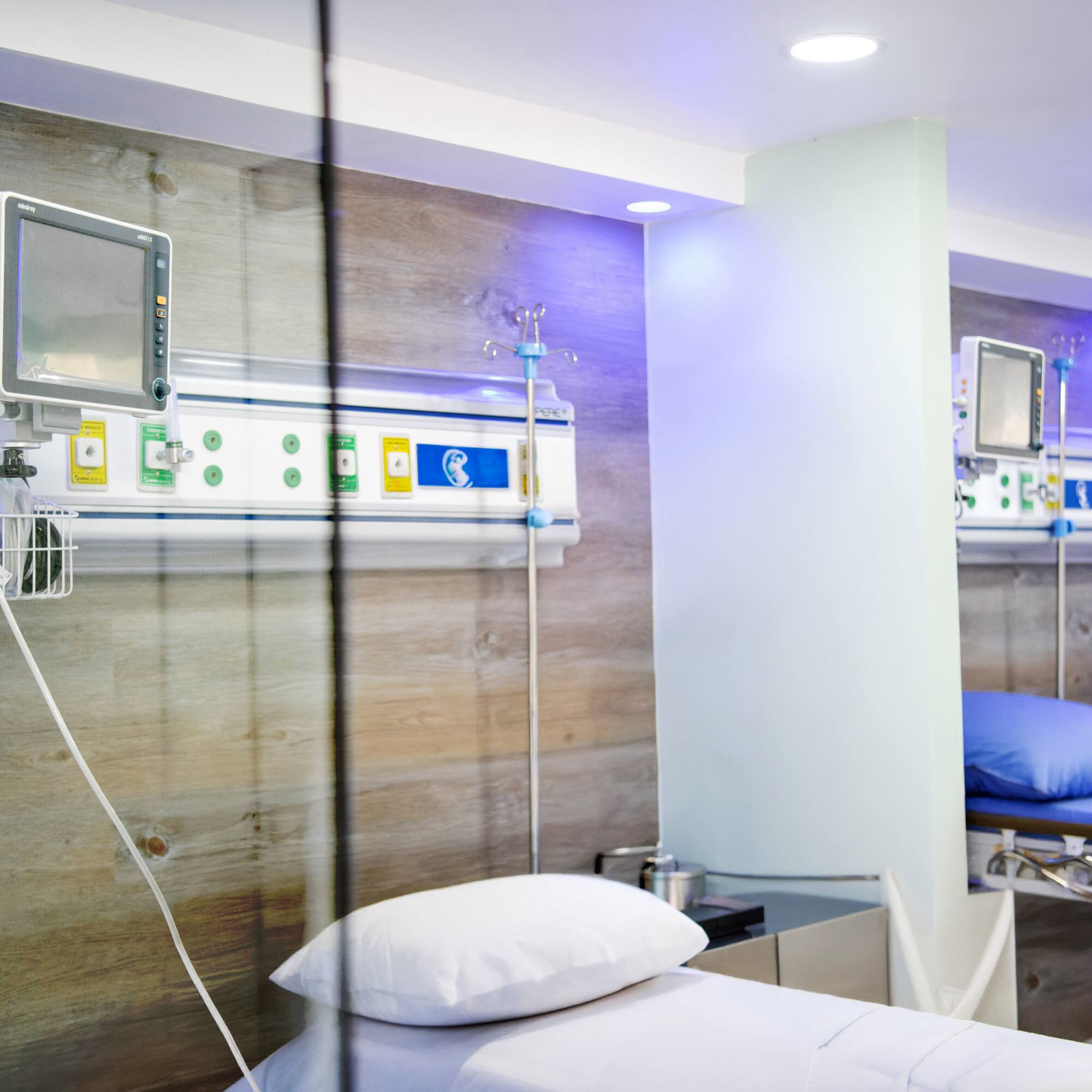 a room with a bed and a monitor