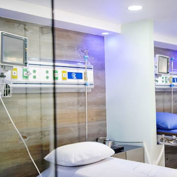 a room with a bed and a monitor