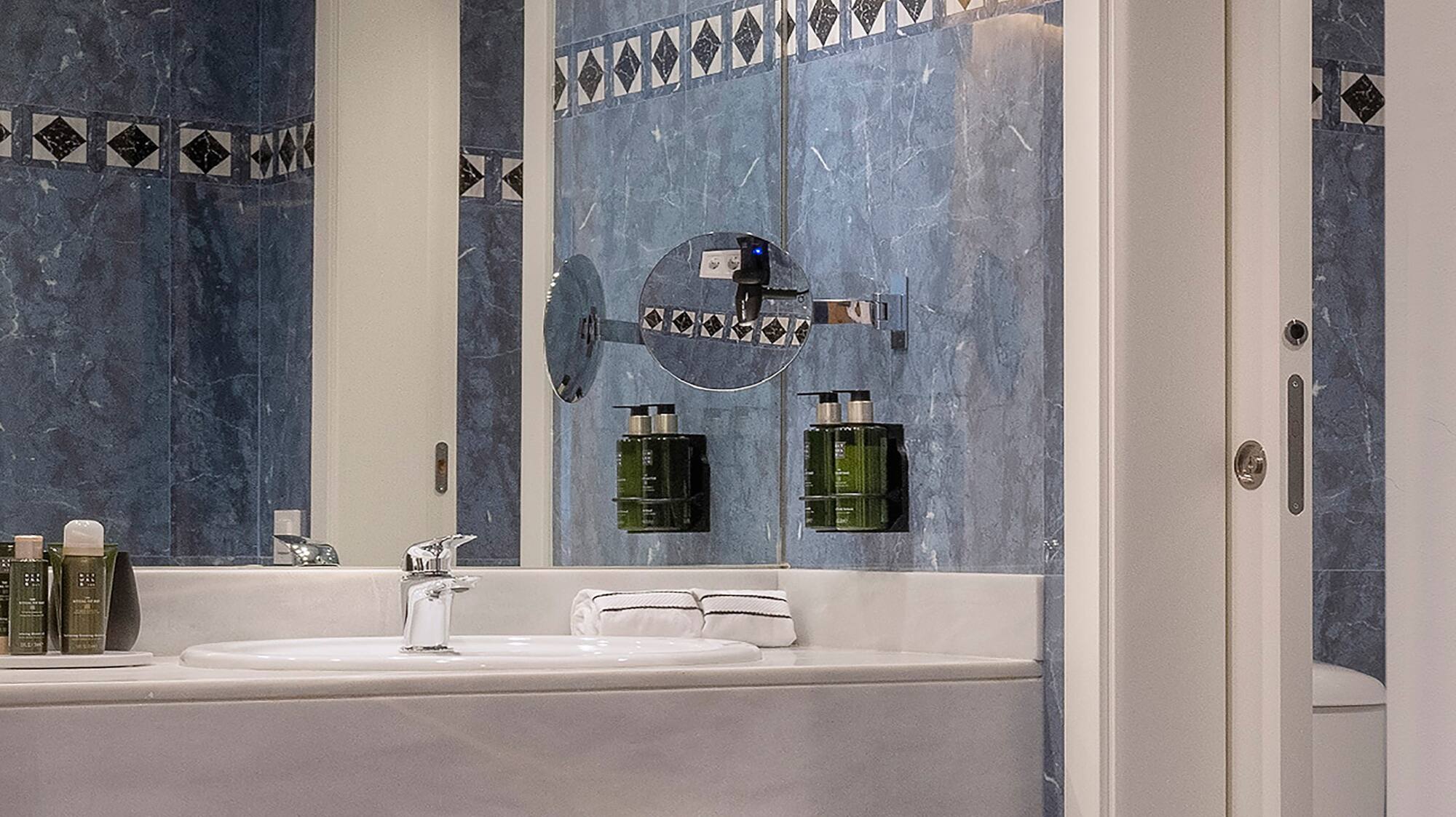 a bathroom with a mirror and sink