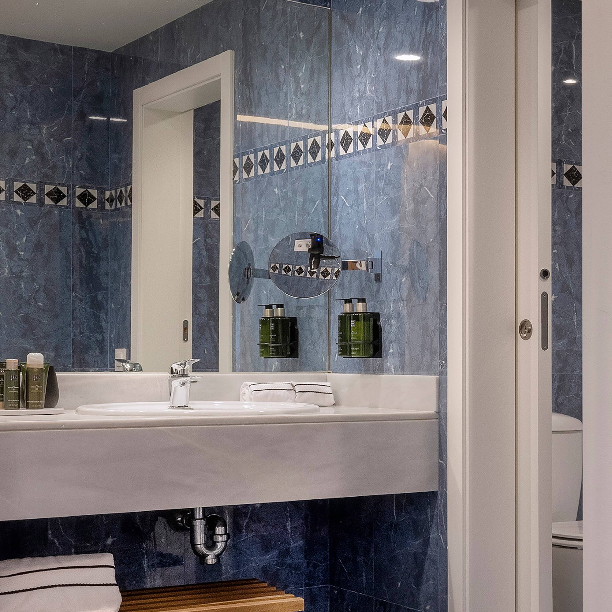 a bathroom with a mirror and sink