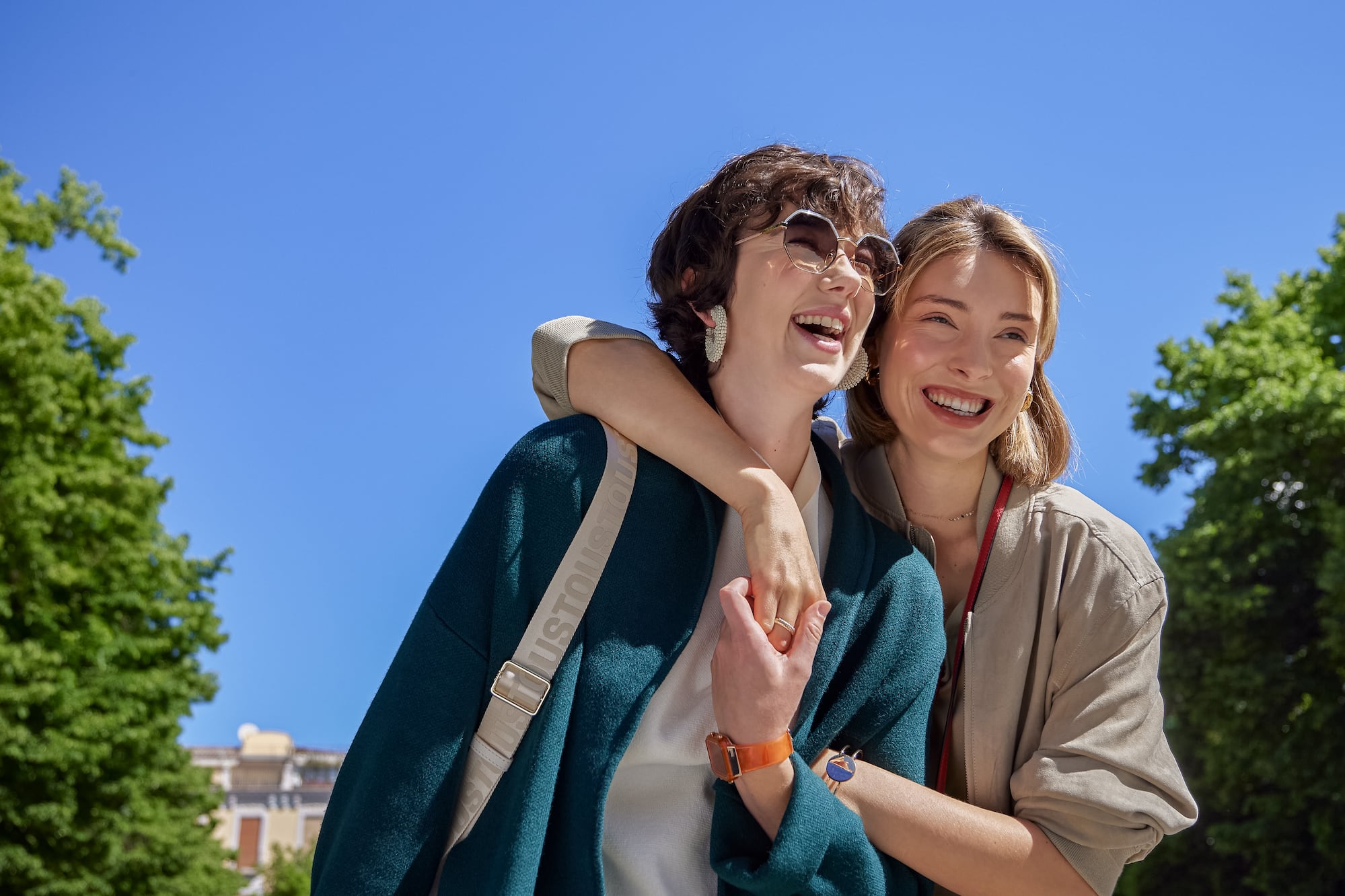 two women standing together smiling