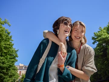 two women standing together smiling
