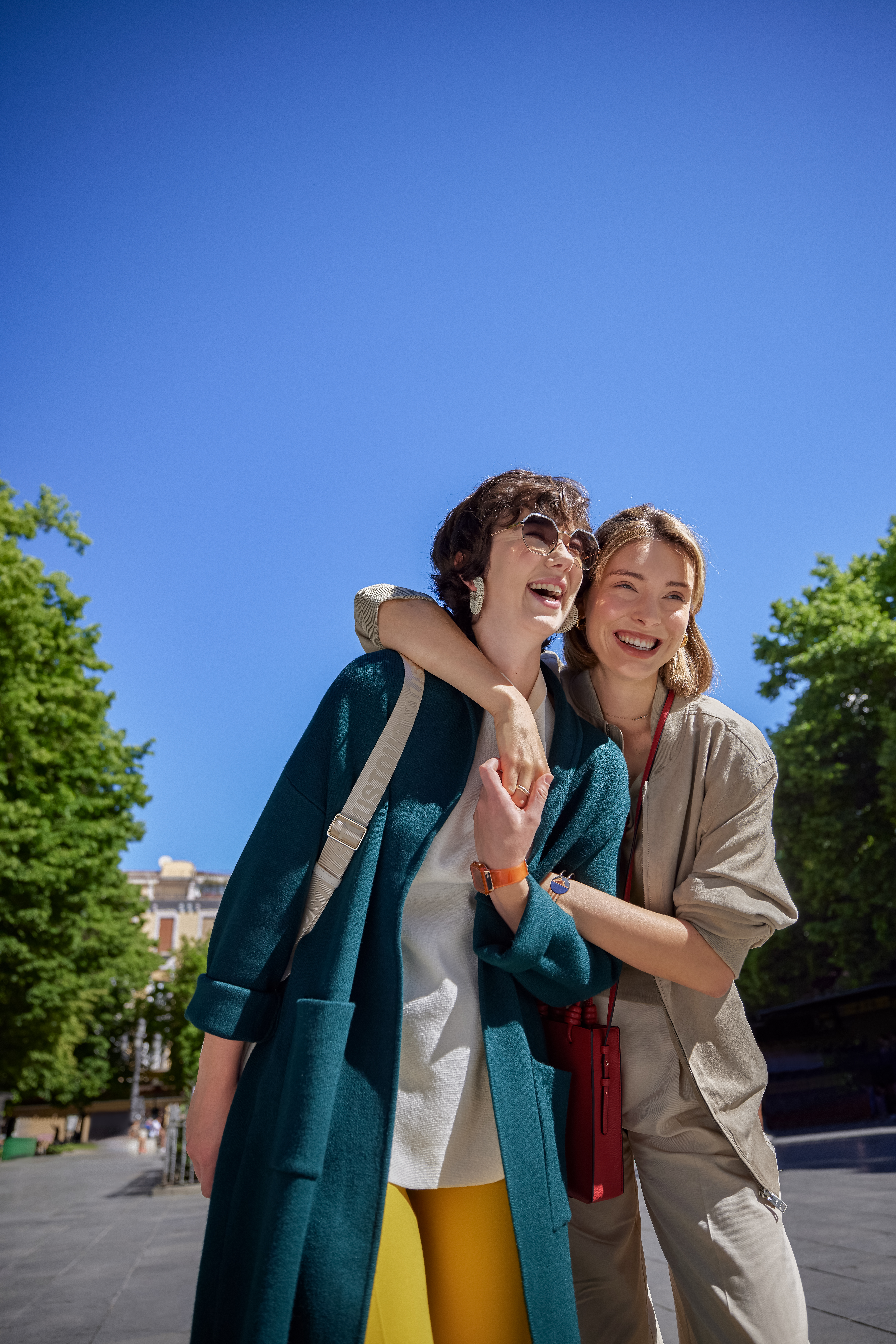 two women standing together smiling