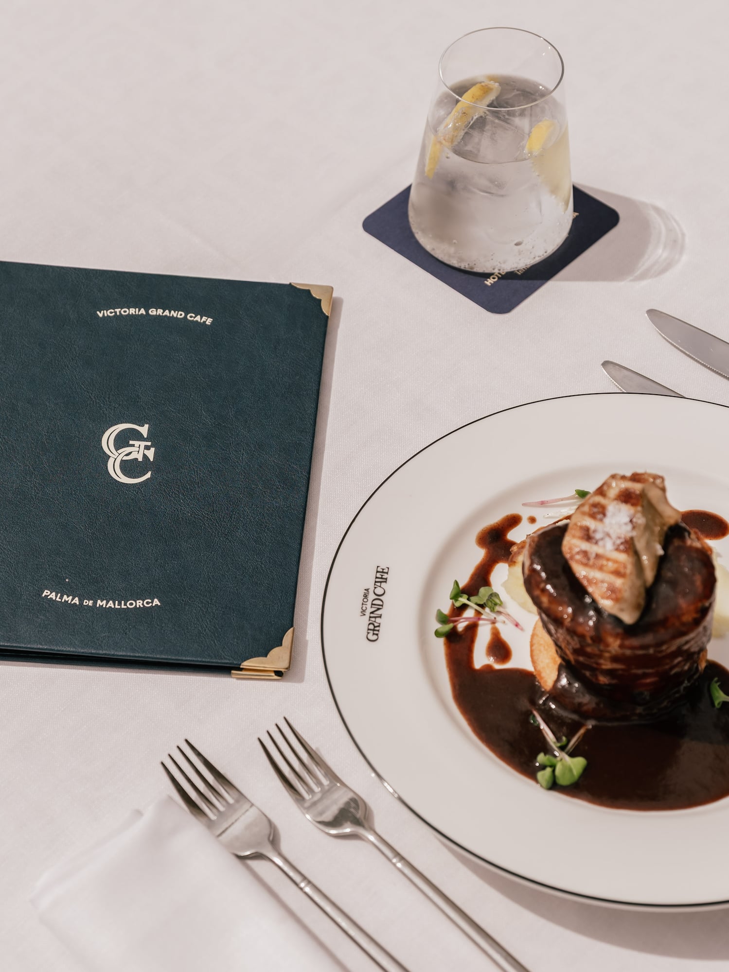 a plate of food on a white plate next to a menu