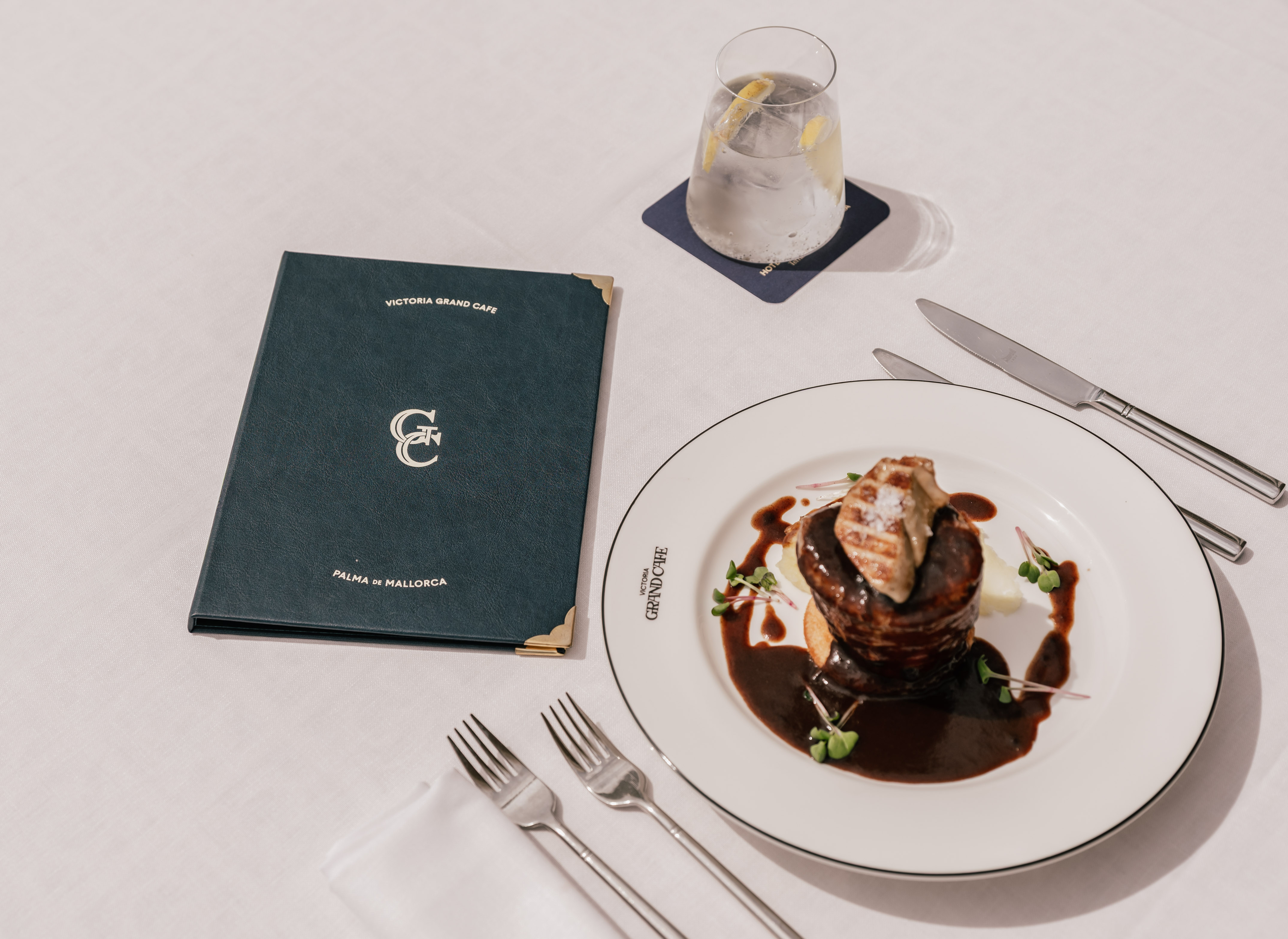a plate of food on a white plate next to a menu