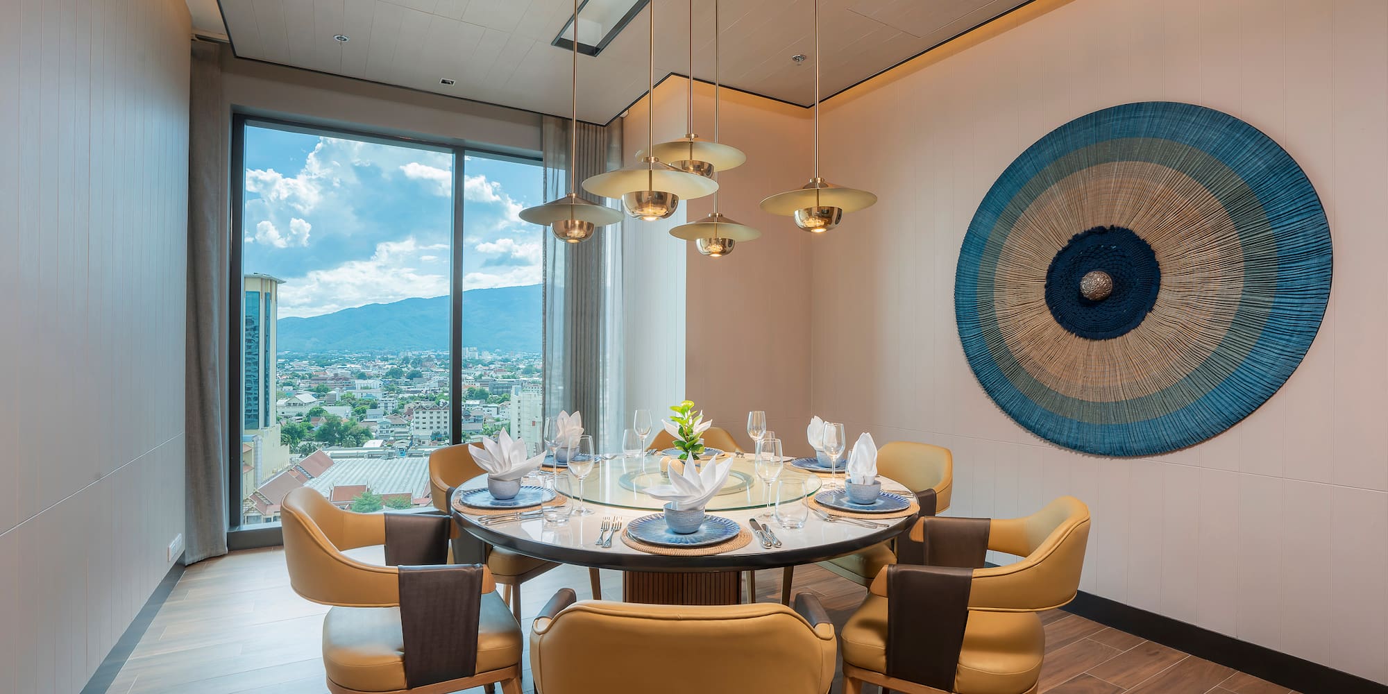 Modern private dining room with round table, city views, elegant design.