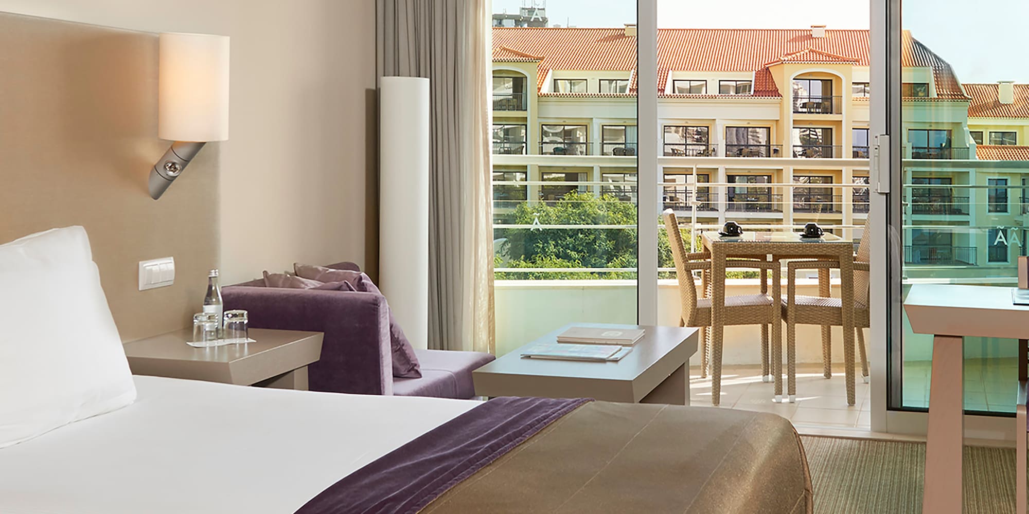 a room with two beds and a table and chairs