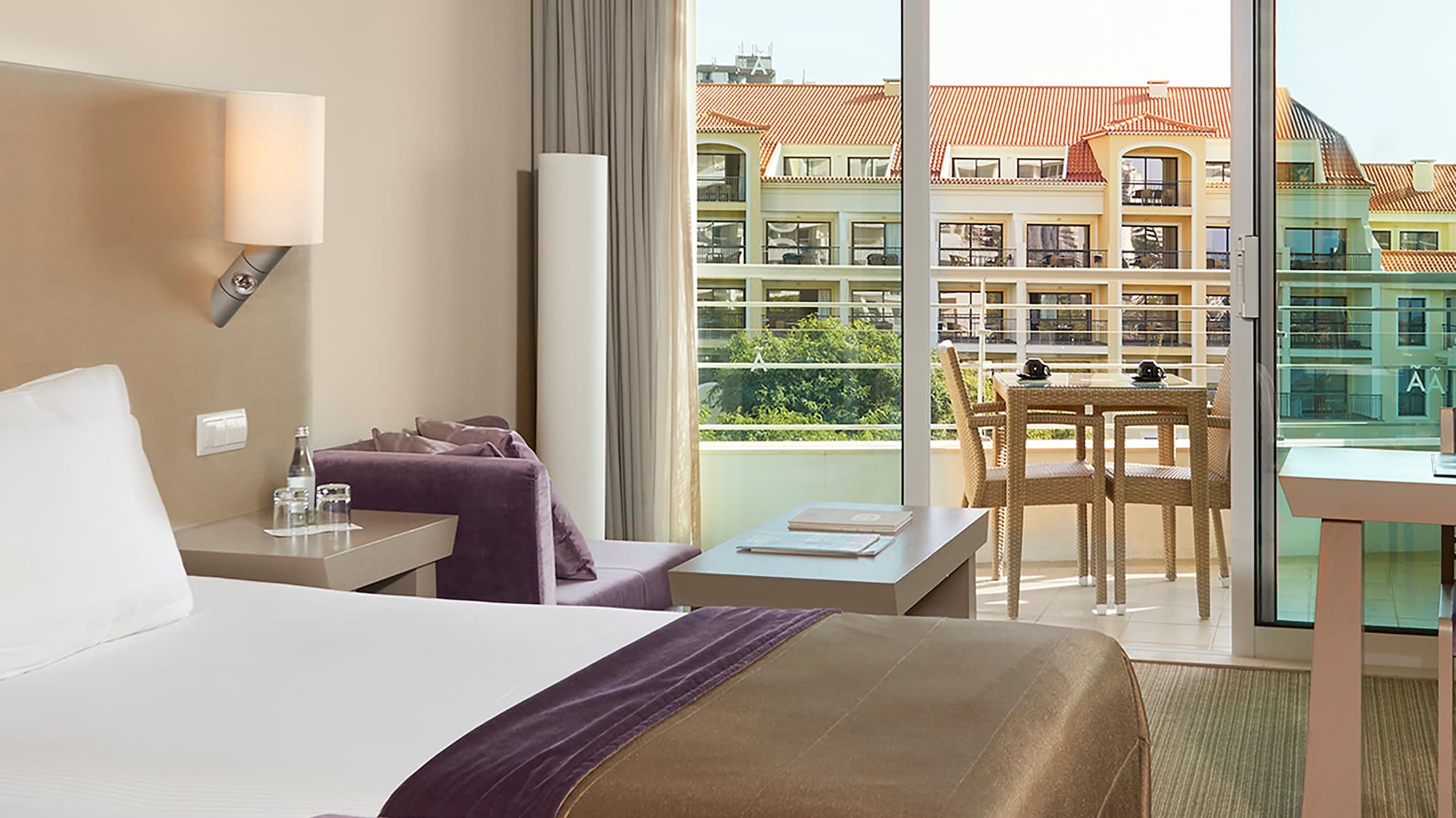 a room with two beds and a table and chairs