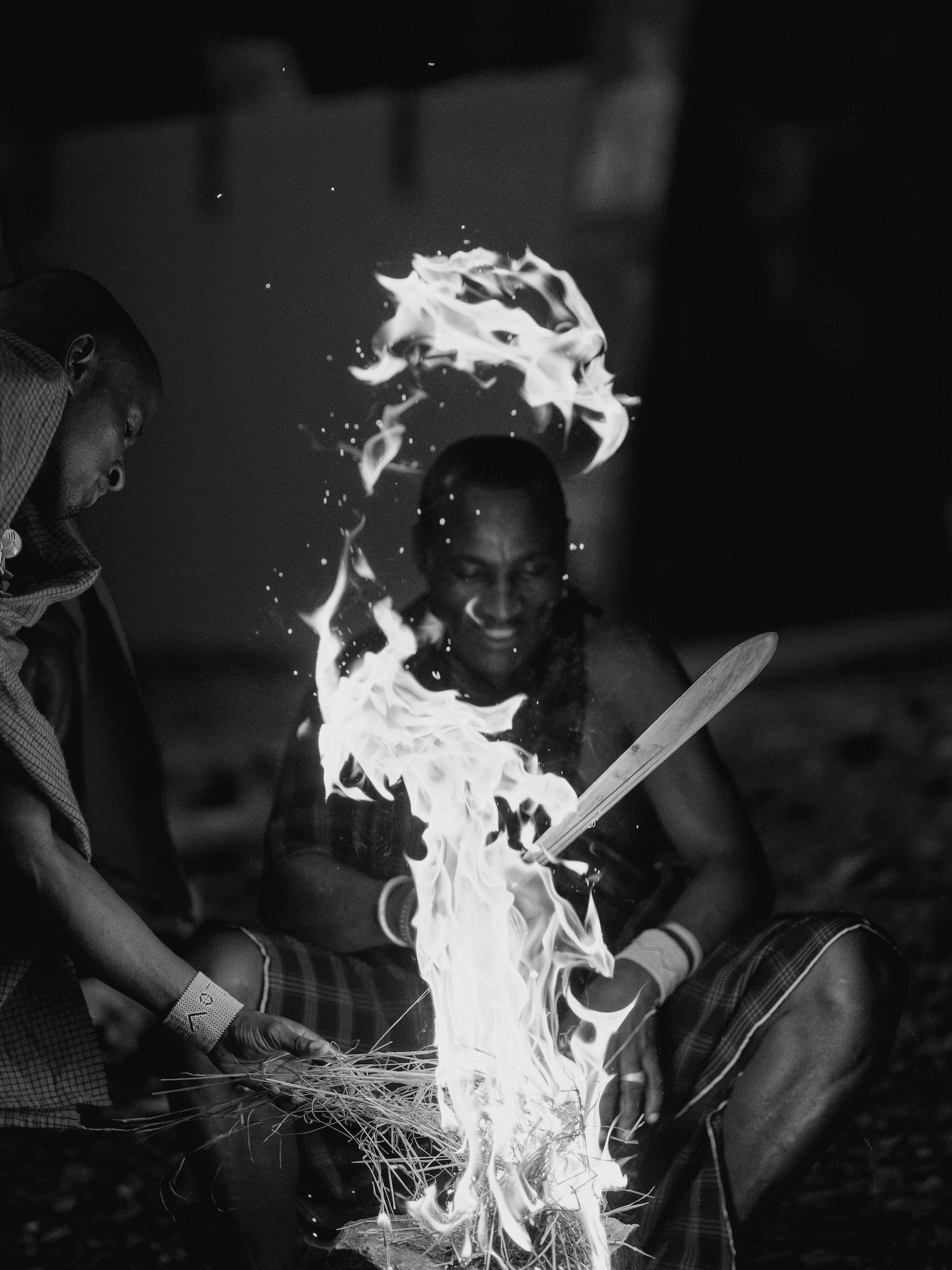 a man sitting in front of a fire