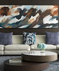 a large painting on a wall above a couch