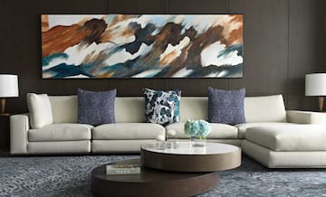 a large painting on a wall above a couch