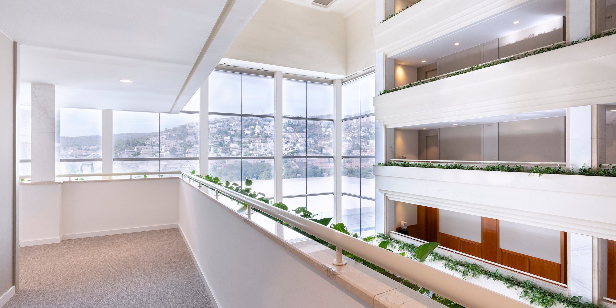 a room with a balcony and plants