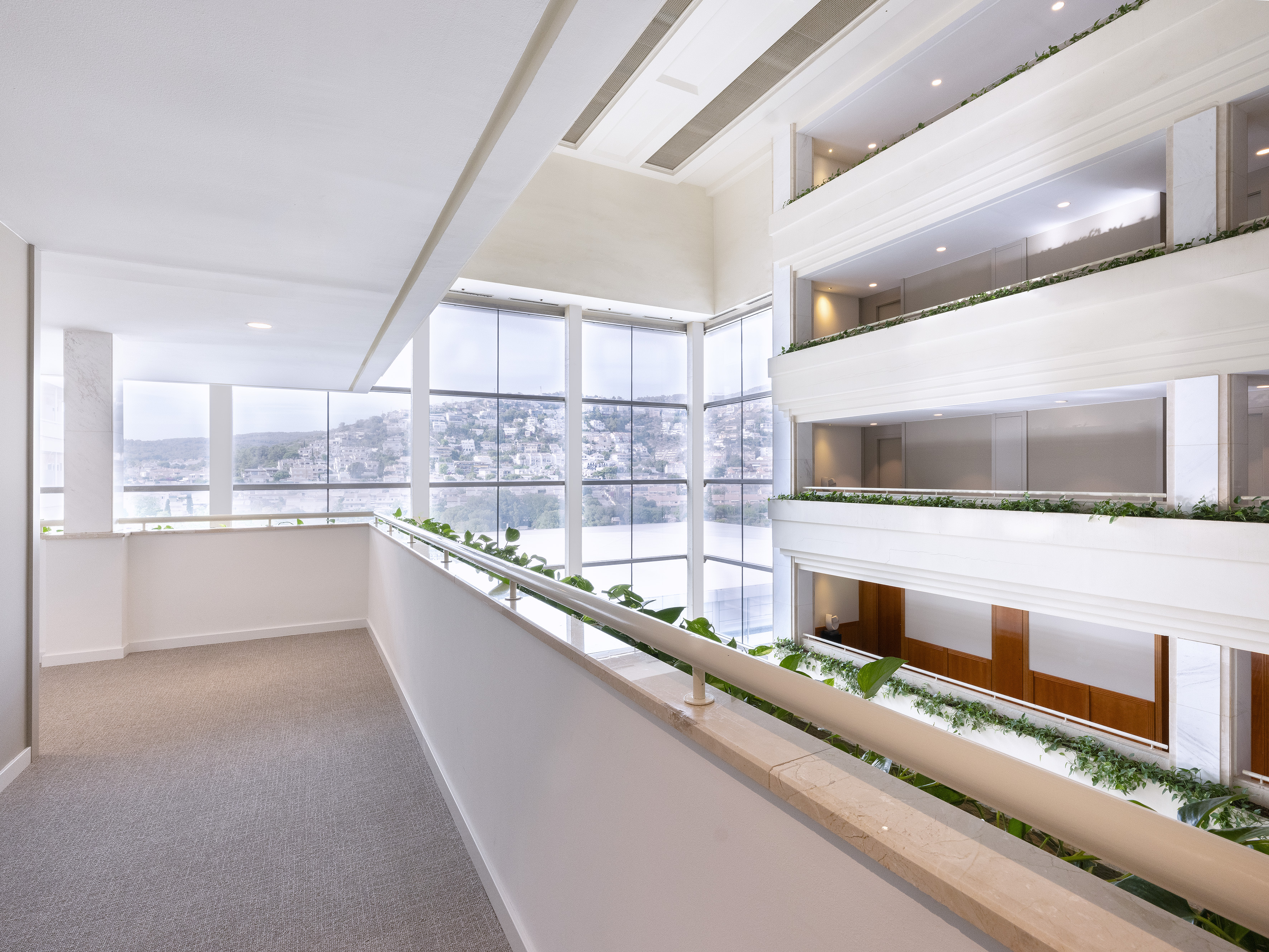 a room with a balcony and plants