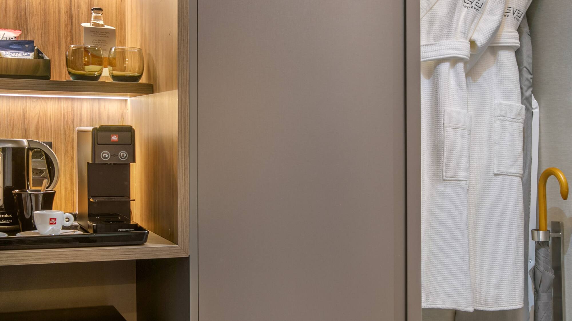 a closet with a white robe and shelves