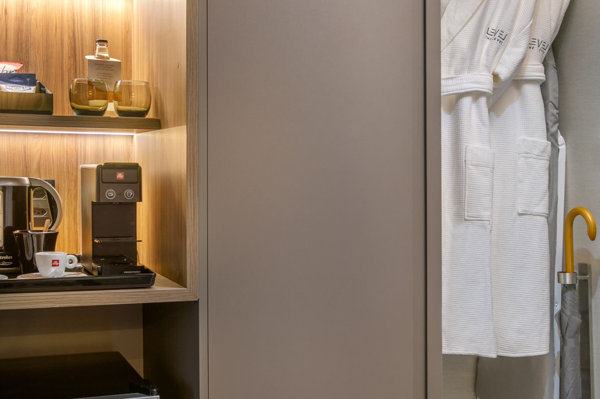 a closet with a white robe and shelves