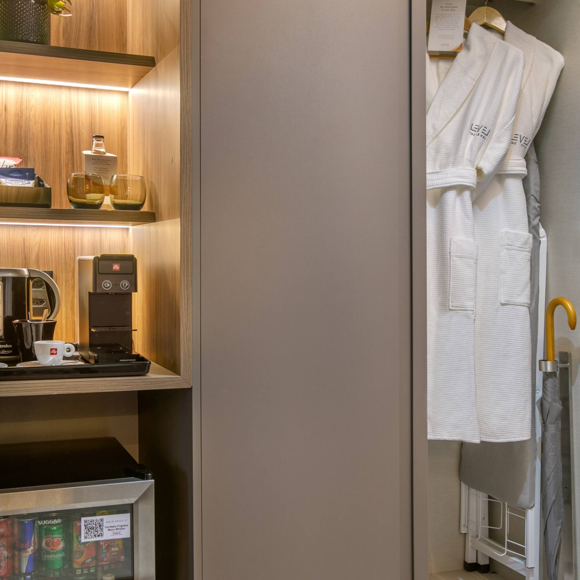 a closet with a white robe and shelves