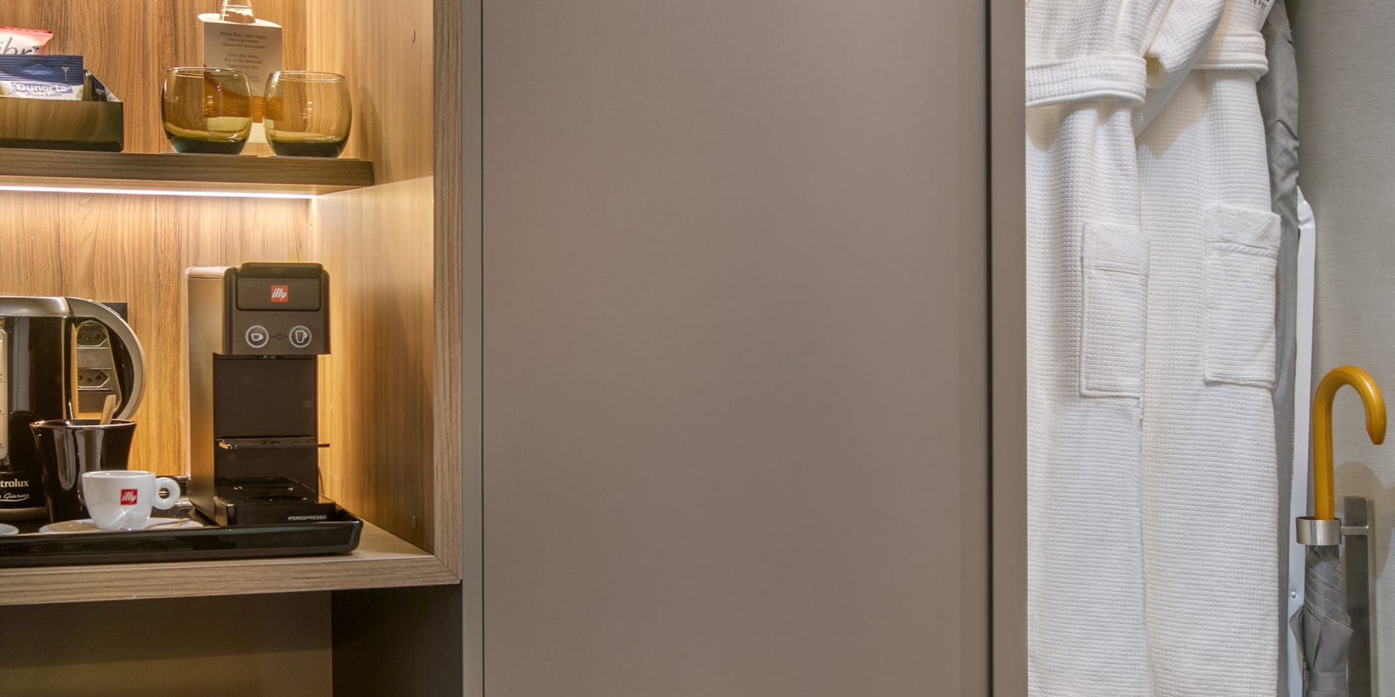 a closet with a white robe and shelves