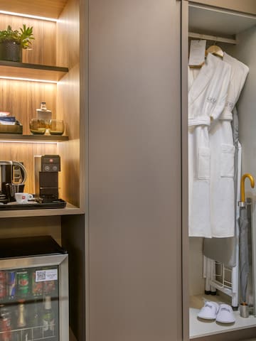 a closet with a white robe and shelves