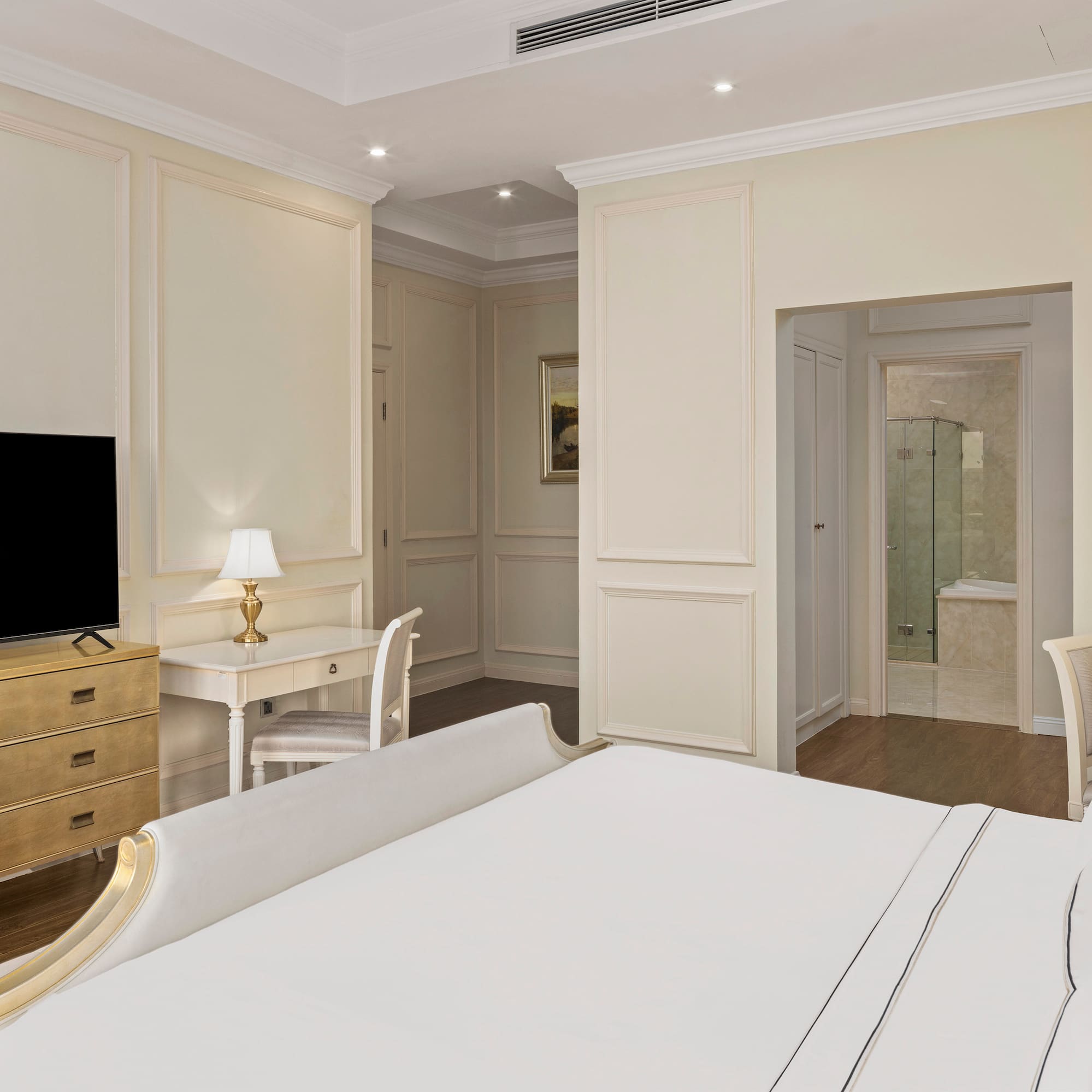 a bedroom with a tv and a dresser