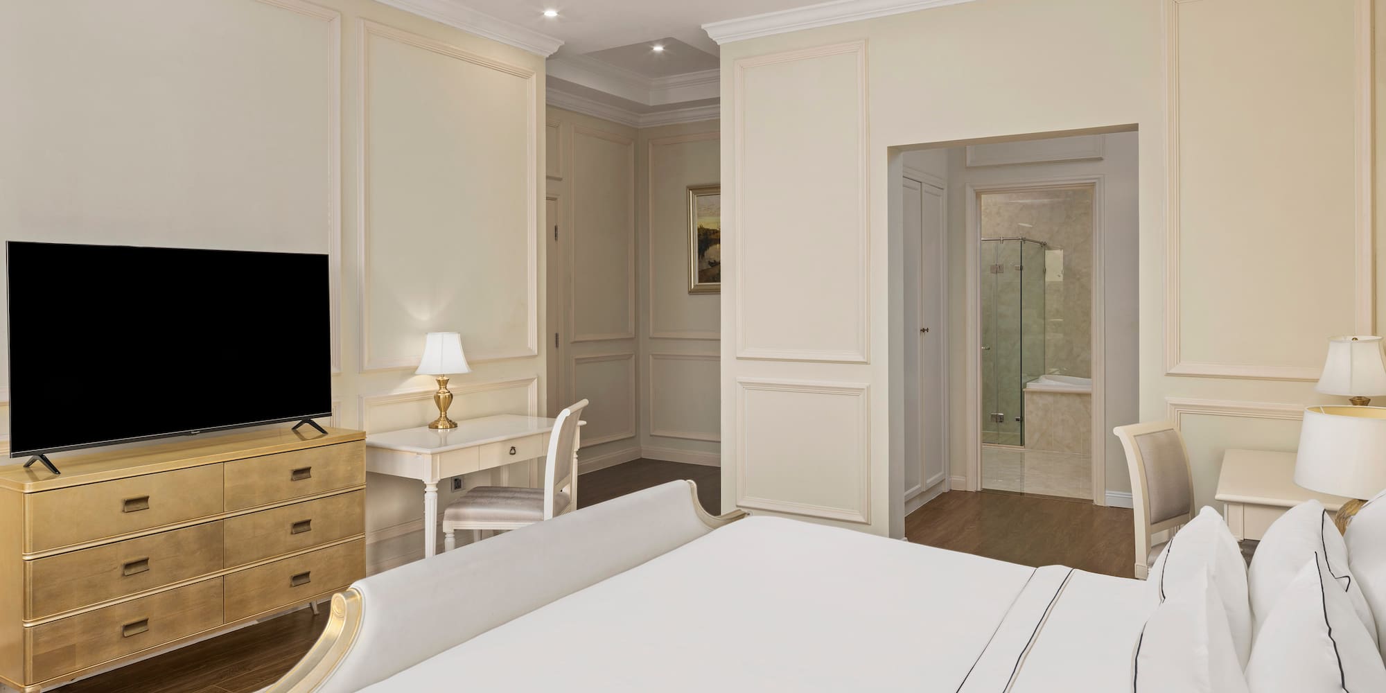 a bedroom with a tv and a dresser