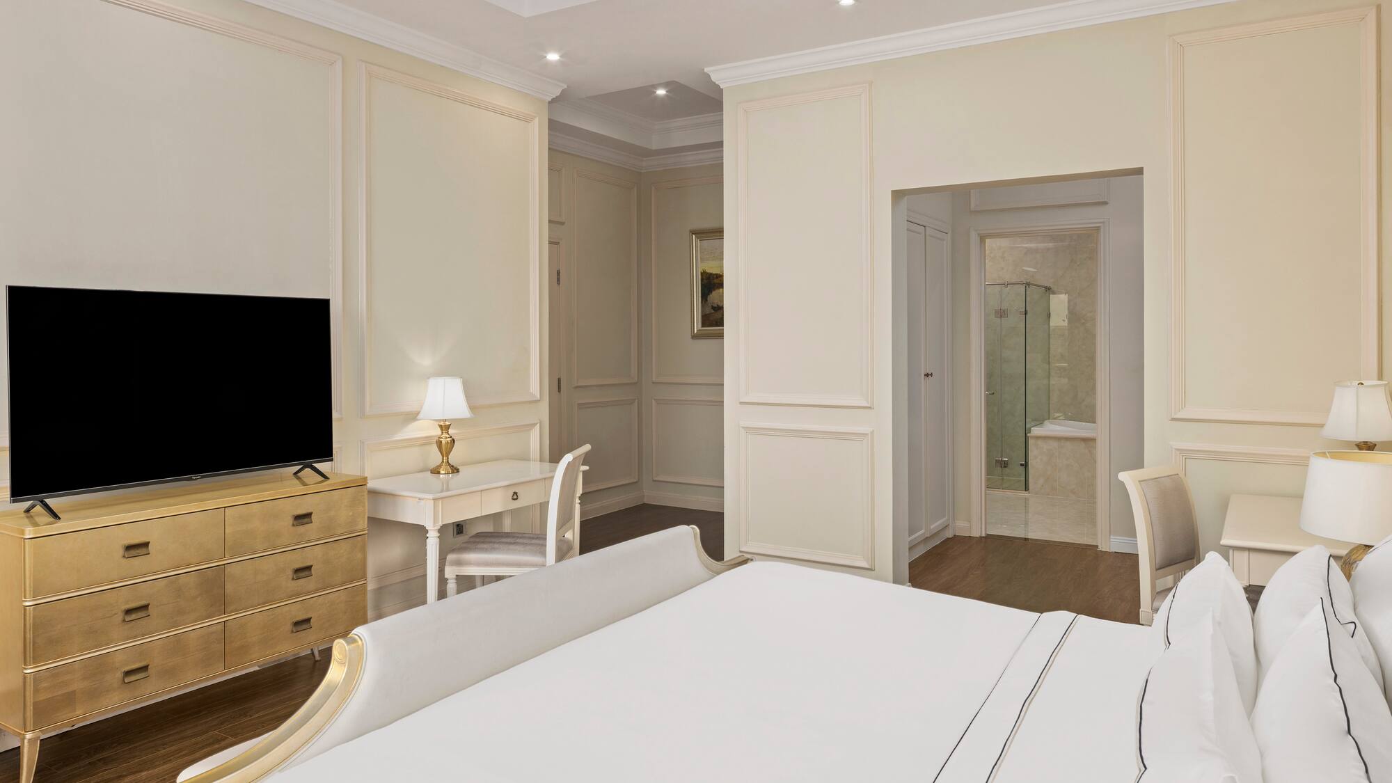 a bedroom with a tv and a dresser