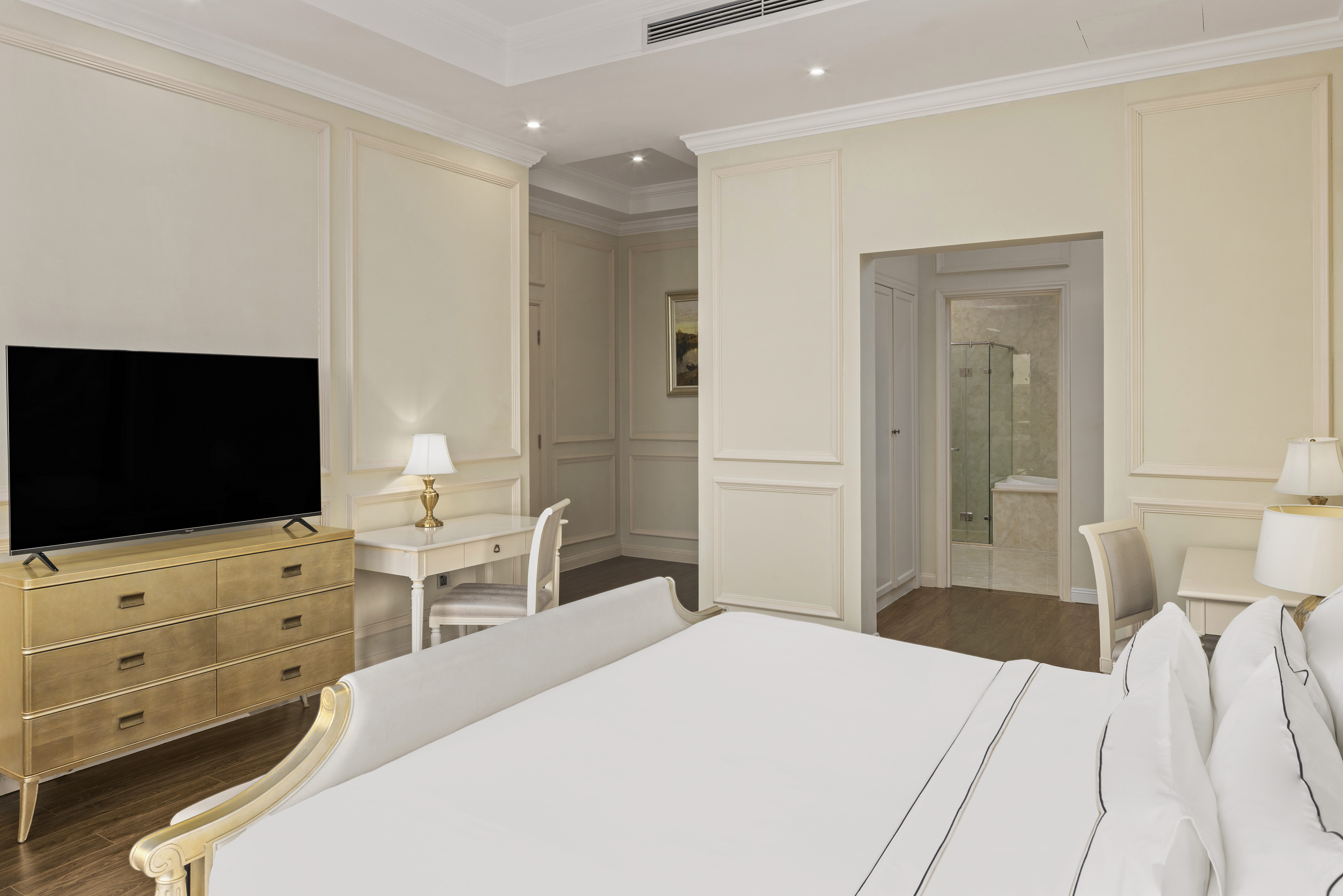a bedroom with a tv and a dresser