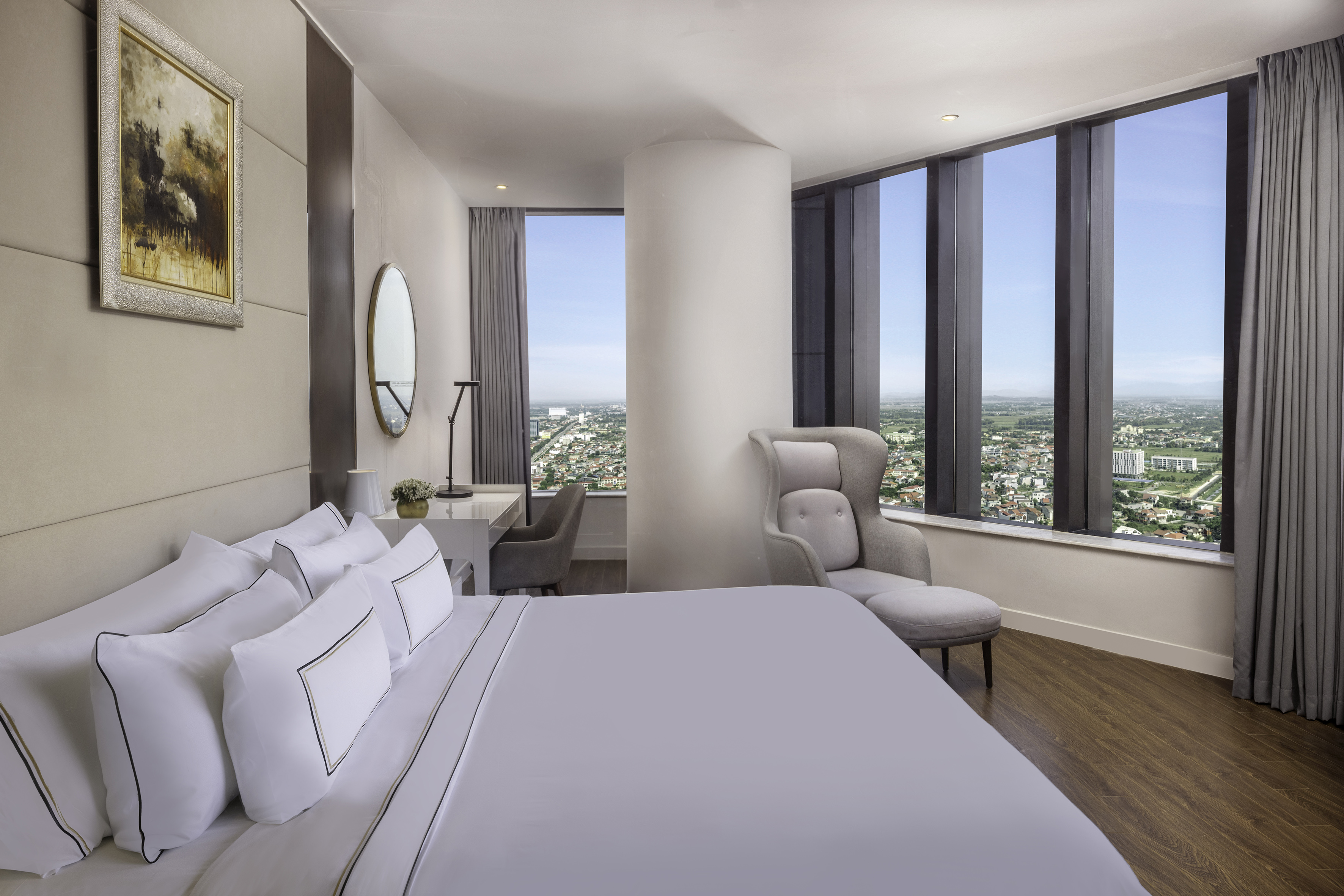 a bedroom with a large window and a large bed