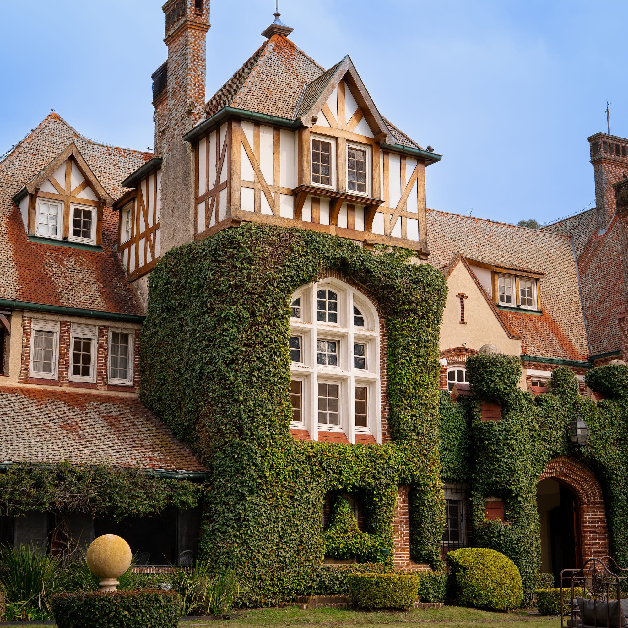 a large house with ivy on the side
