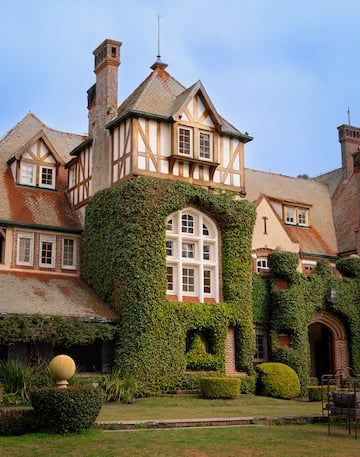 a large house with ivy on the side