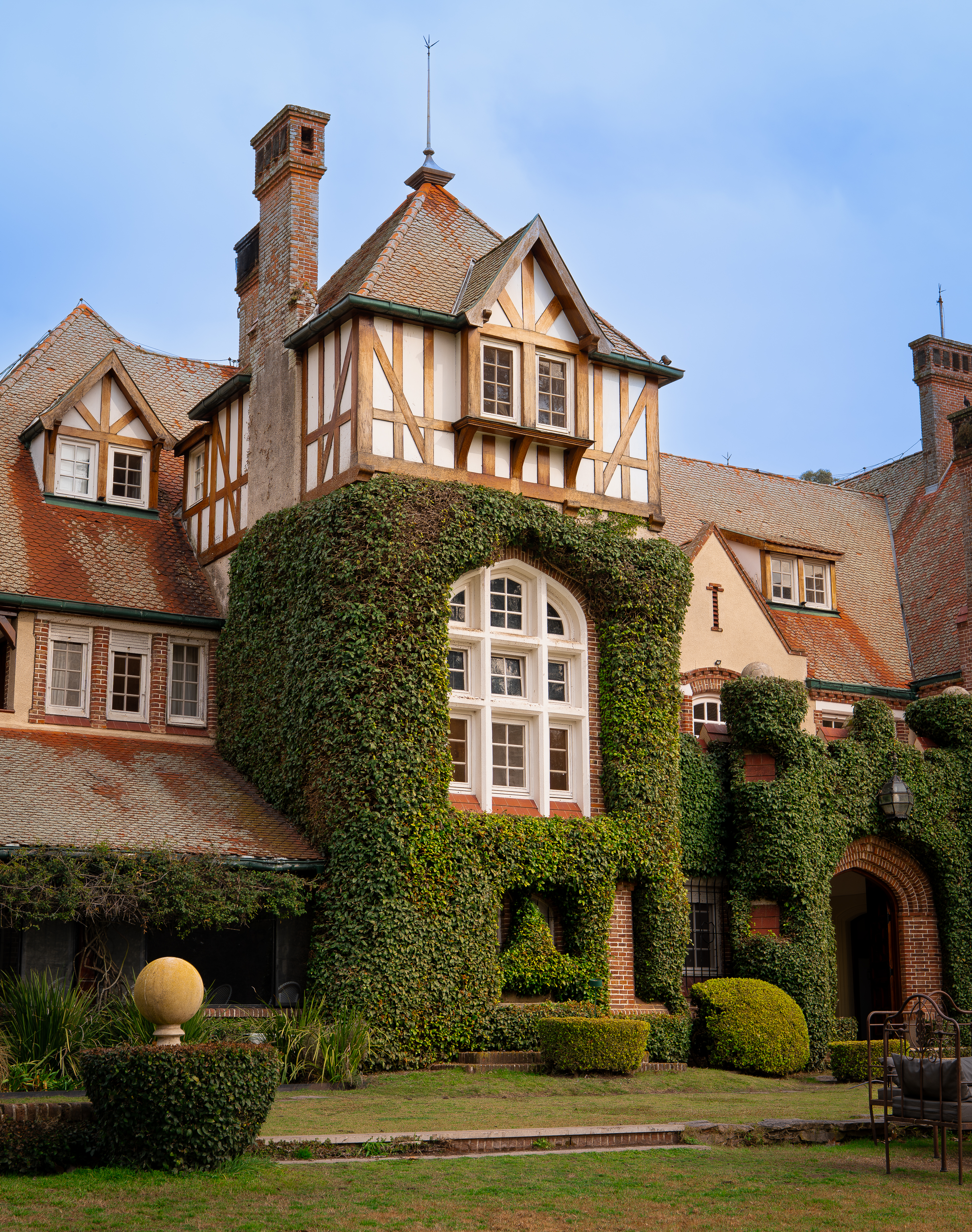 a large house with ivy on the side