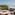 Coastal rooftop terrace with ocean view, lounge chairs, yoga mat.