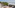 Coastal rooftop terrace with ocean view, lounge chairs, yoga mat.