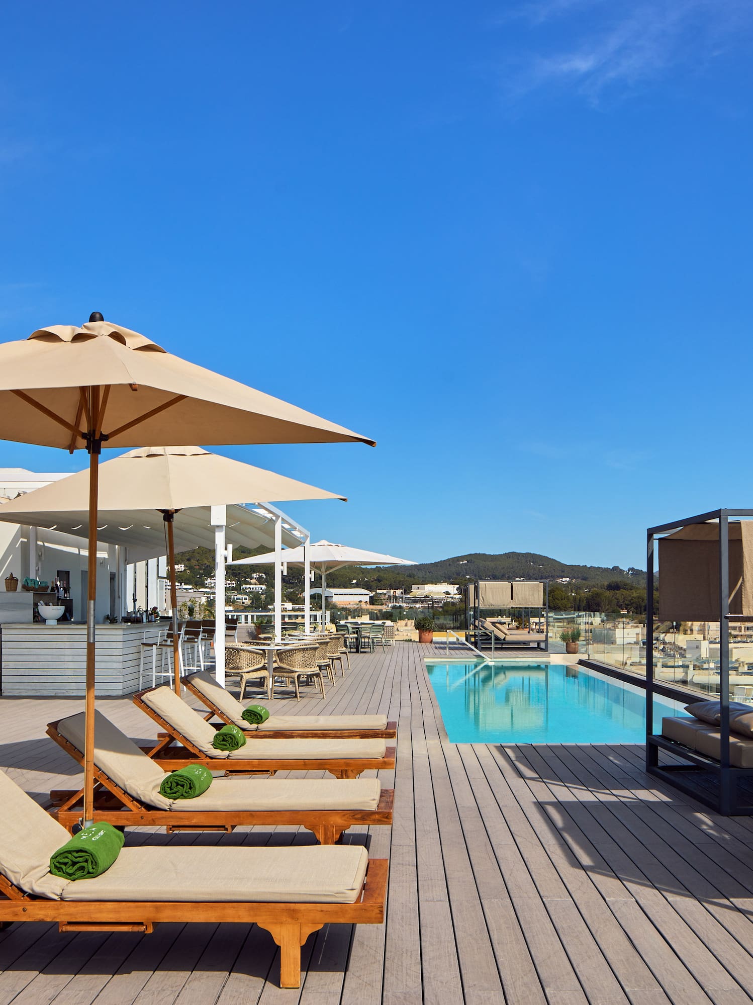 a pool with lounge chairs and umbrellas