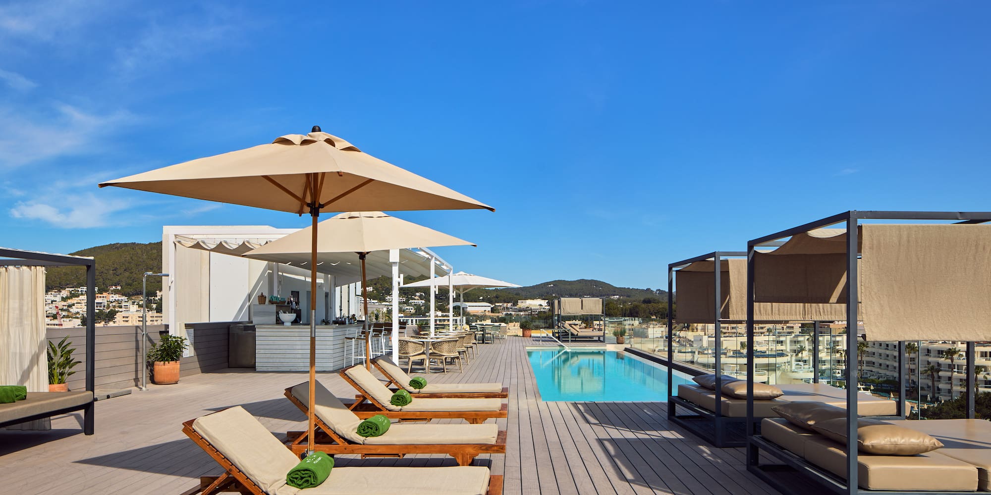a pool with lounge chairs and umbrellas
