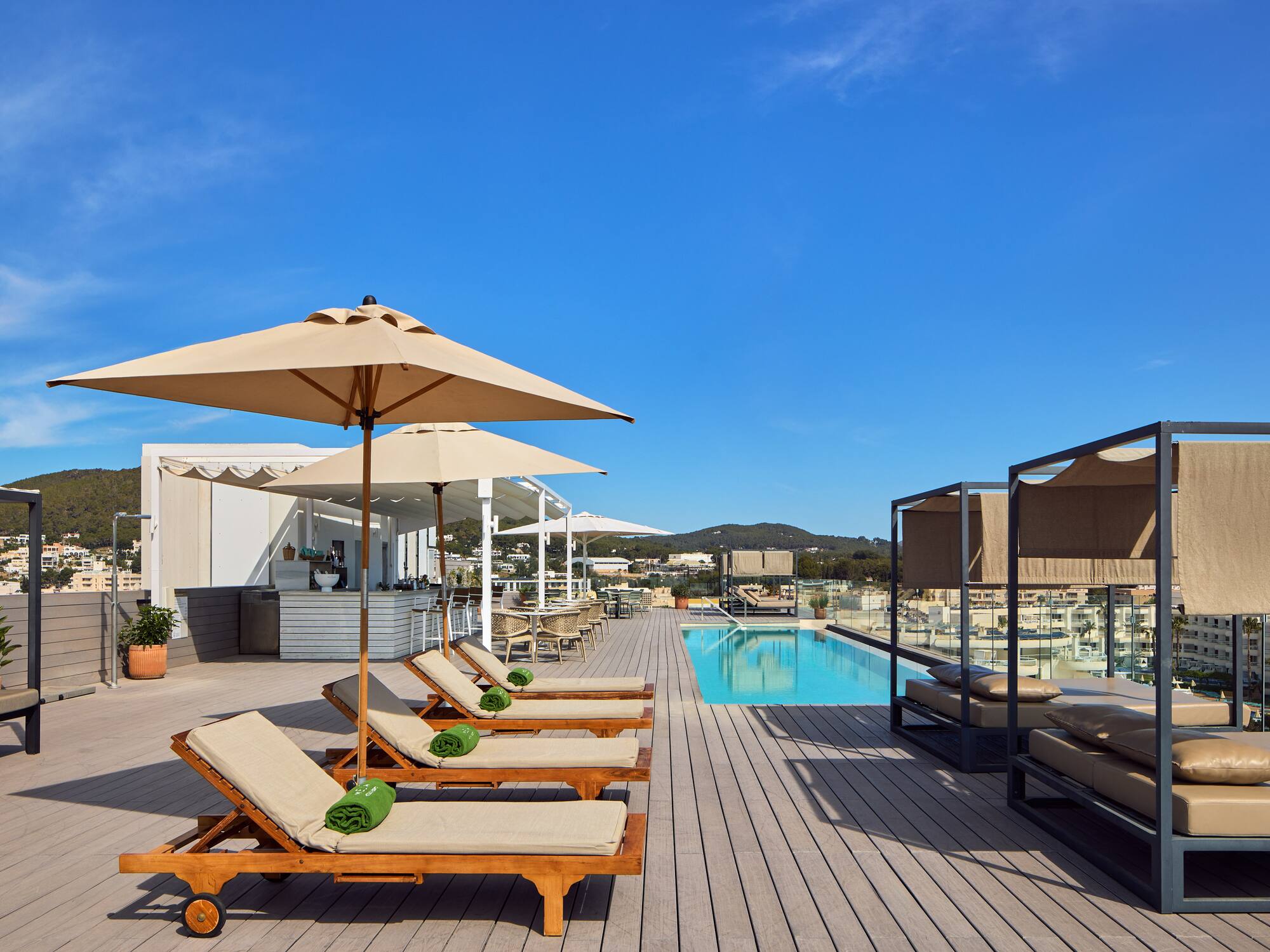 a pool with lounge chairs and umbrellas