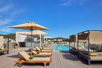 a pool with lounge chairs and umbrellas