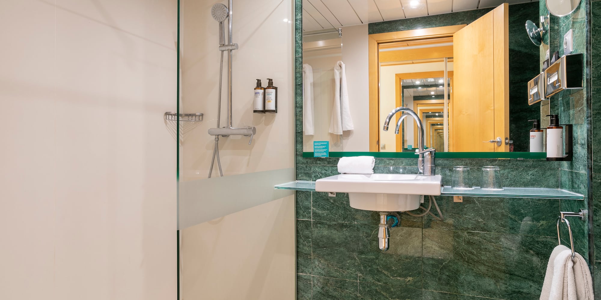 a bathroom with a glass shower and sink