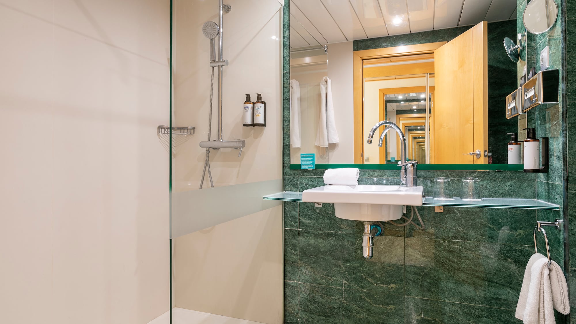 a bathroom with a glass shower and sink